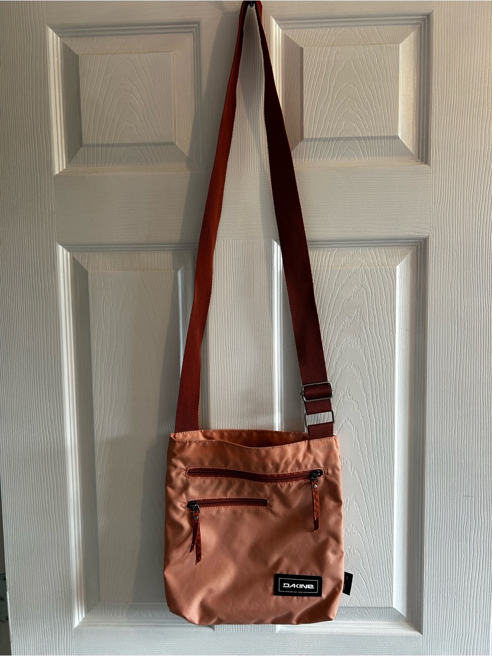 Dakine Crossbody Bag in a coral orange color with Rust Strap
